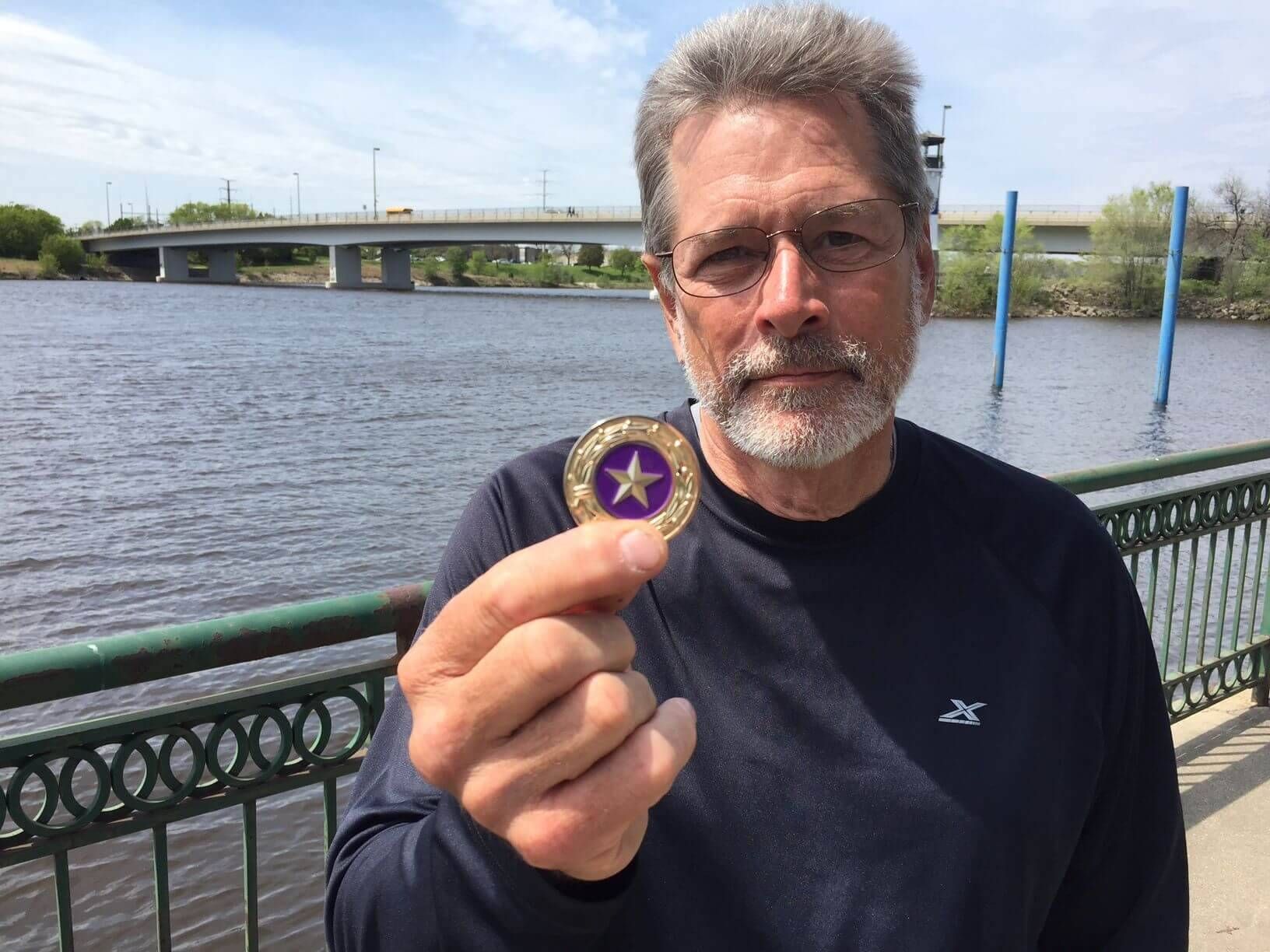 Man holding a coin with a star on it