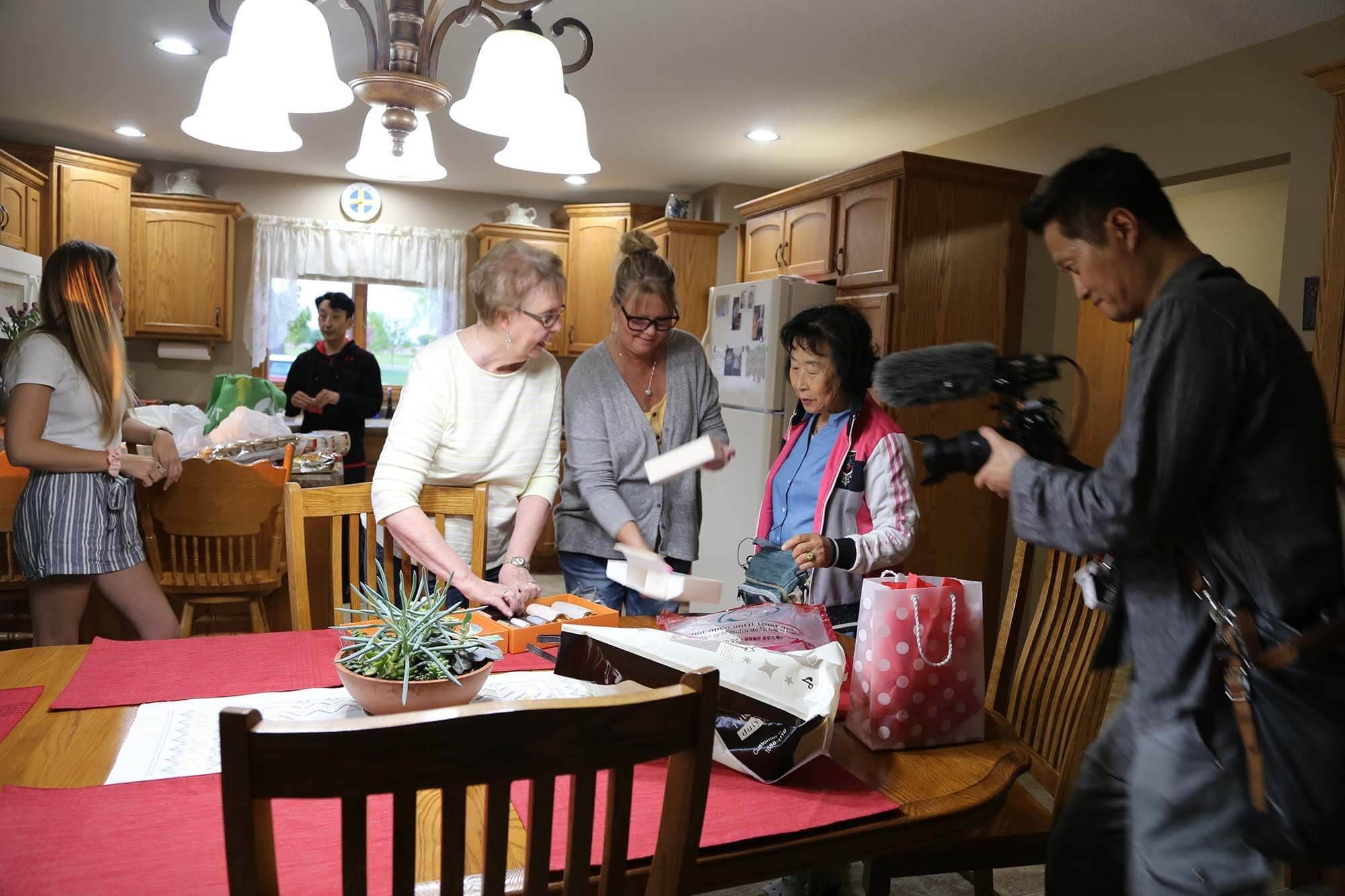 Fostervold's adoptive mother and sister Lynn Wells, 51, exchange gifts with his biological mother, as Korean filmmaker Wangmo Yeon captures the moment.