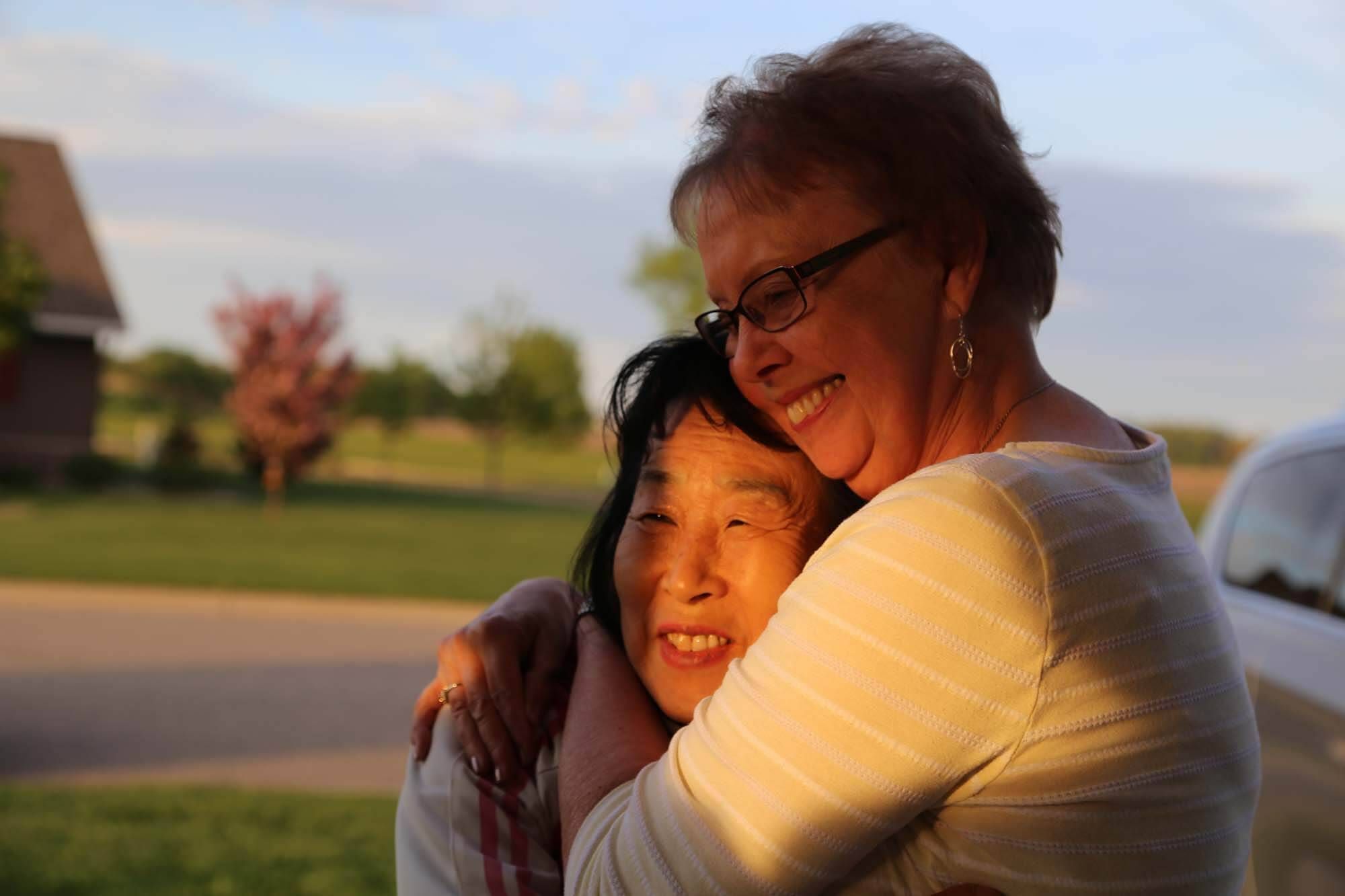 Sook-nyeon Kim, 71, and Lois Fostervold, 75, embrace after meeting for the first time in Willmar, Minnesota.