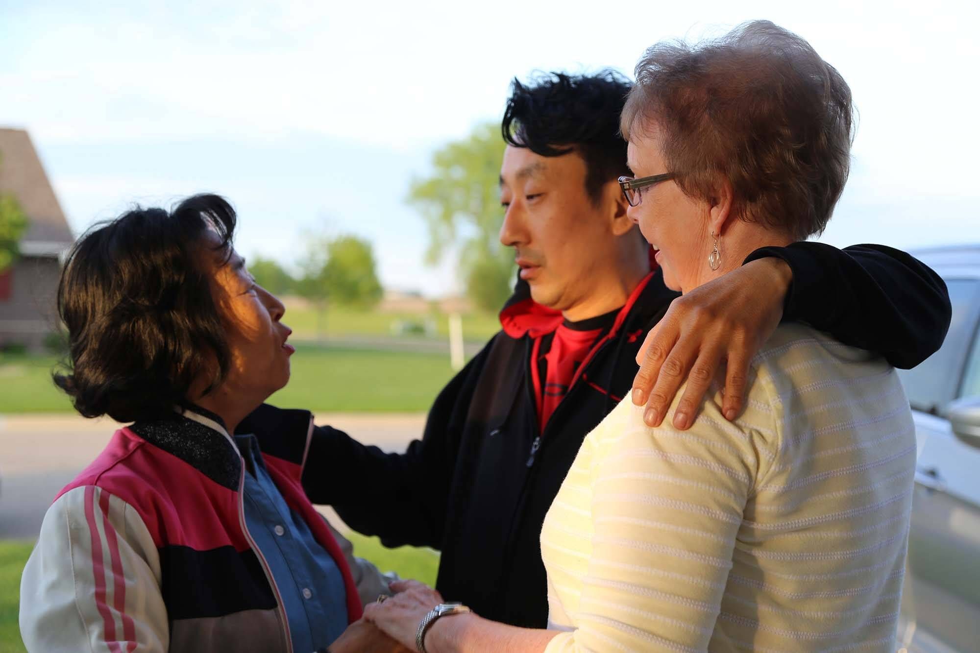 Layne Fostervold, 47, is surrounded by both his mothers in Willmar, Minnesota.