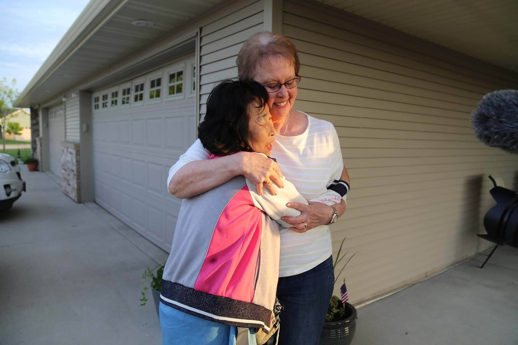 Sook-nyeon Kim, 72, and Lois Fostervold, 75, embrace upon meeting for the first time after Kim flew to Minnesota to meet her son's American mother.  