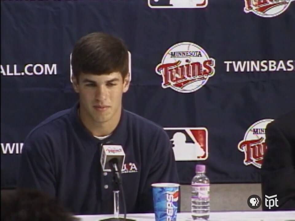 Joe Mauer sits at a table during the press conference that announces he will join the Minnesota Twins.