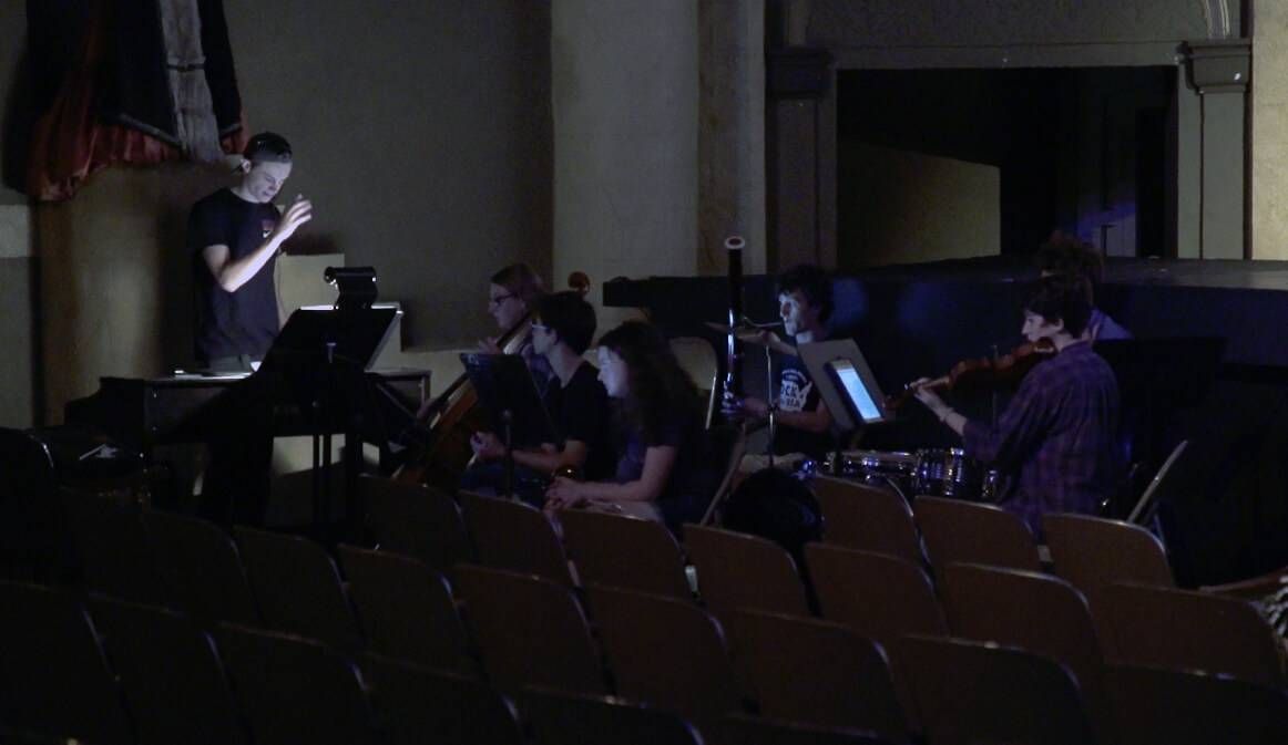 Sam Dwyer conducting the orchestra