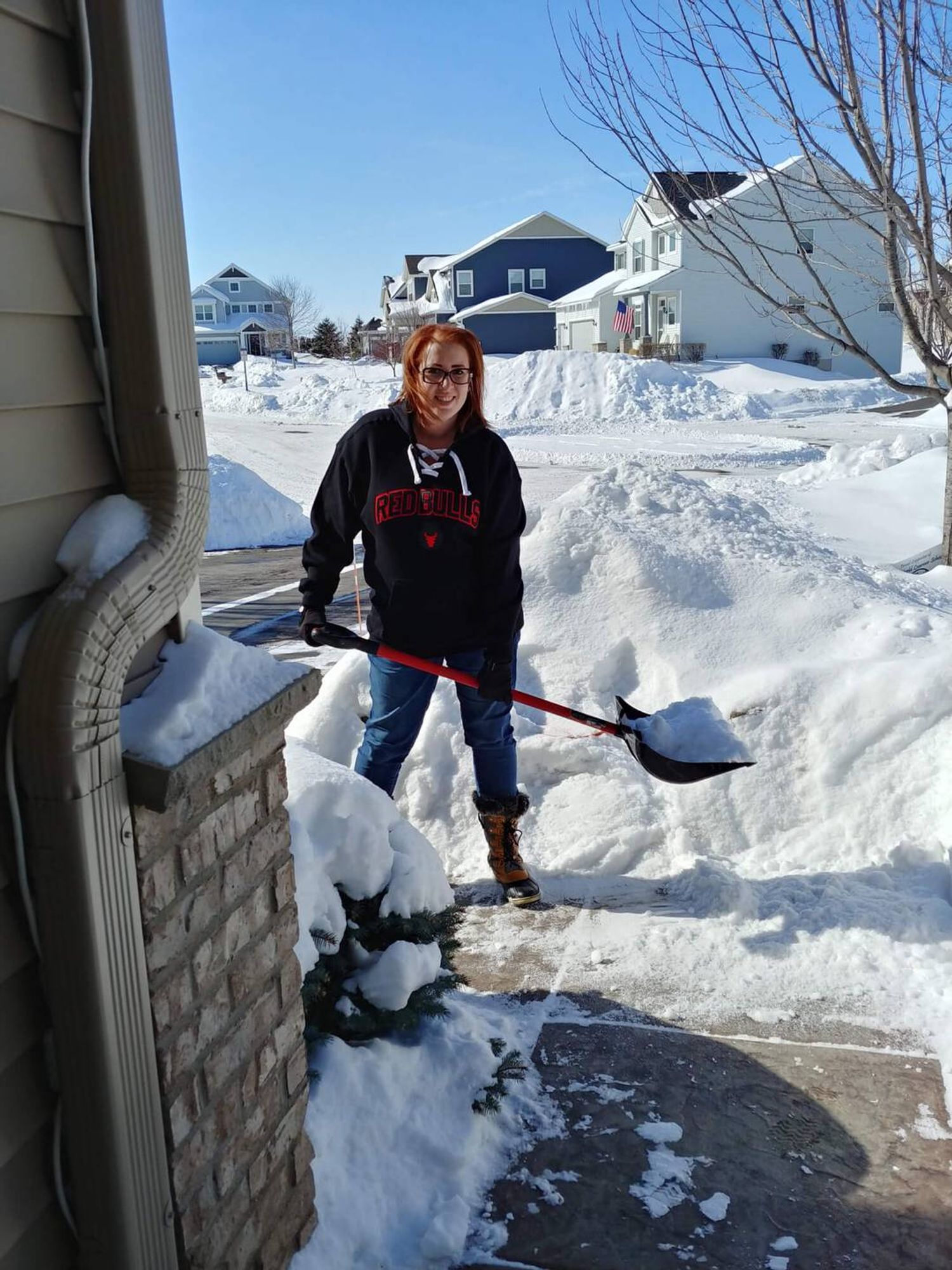 Amy shovels snow during an especially rough winter in Minnesota. Photo courtesy of the author.