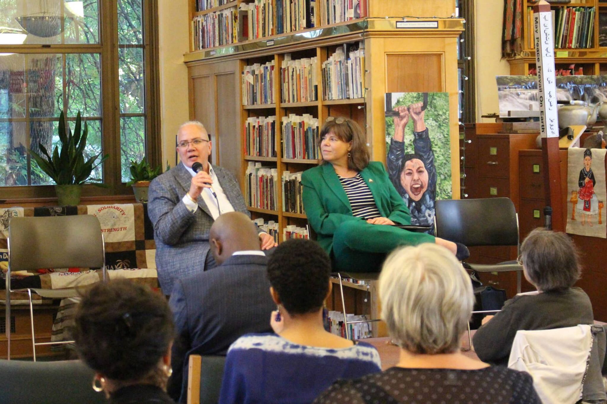 Two women talking to a group at a library