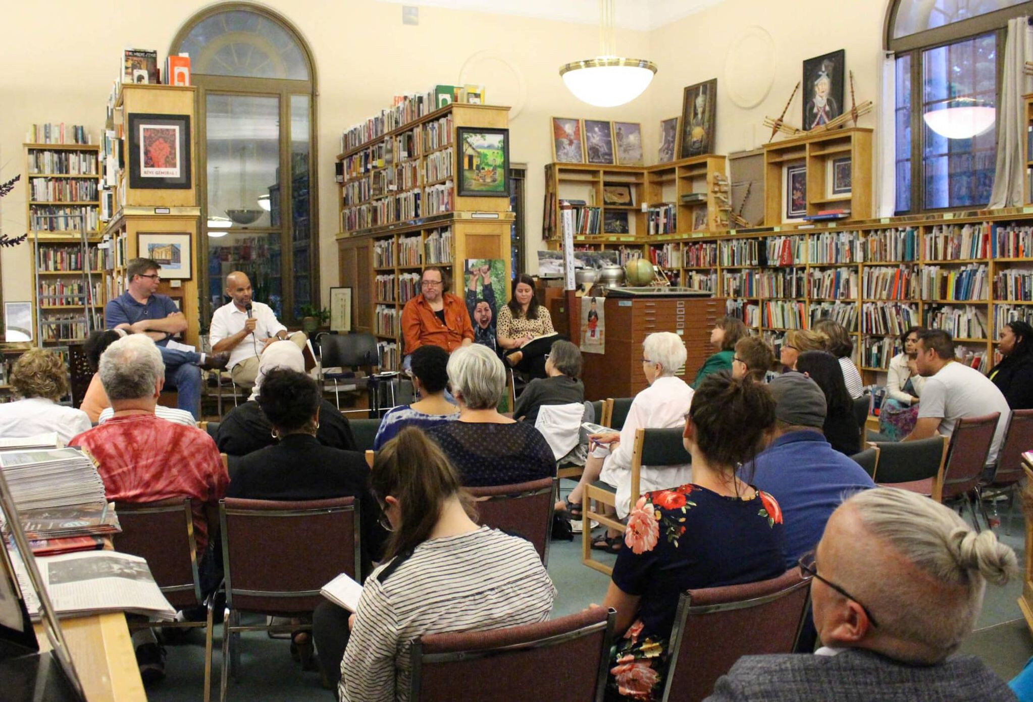 Panel of people talking to a group in a library