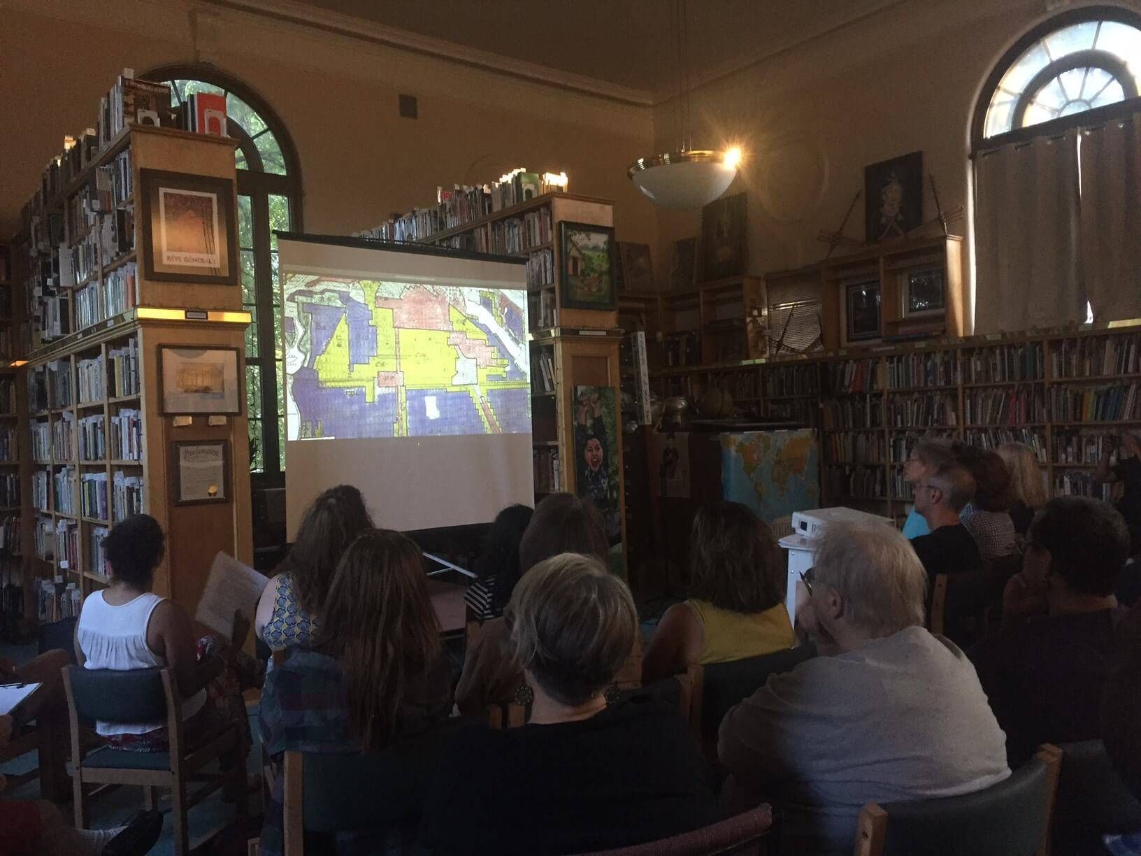 Group of people watching a film at a library