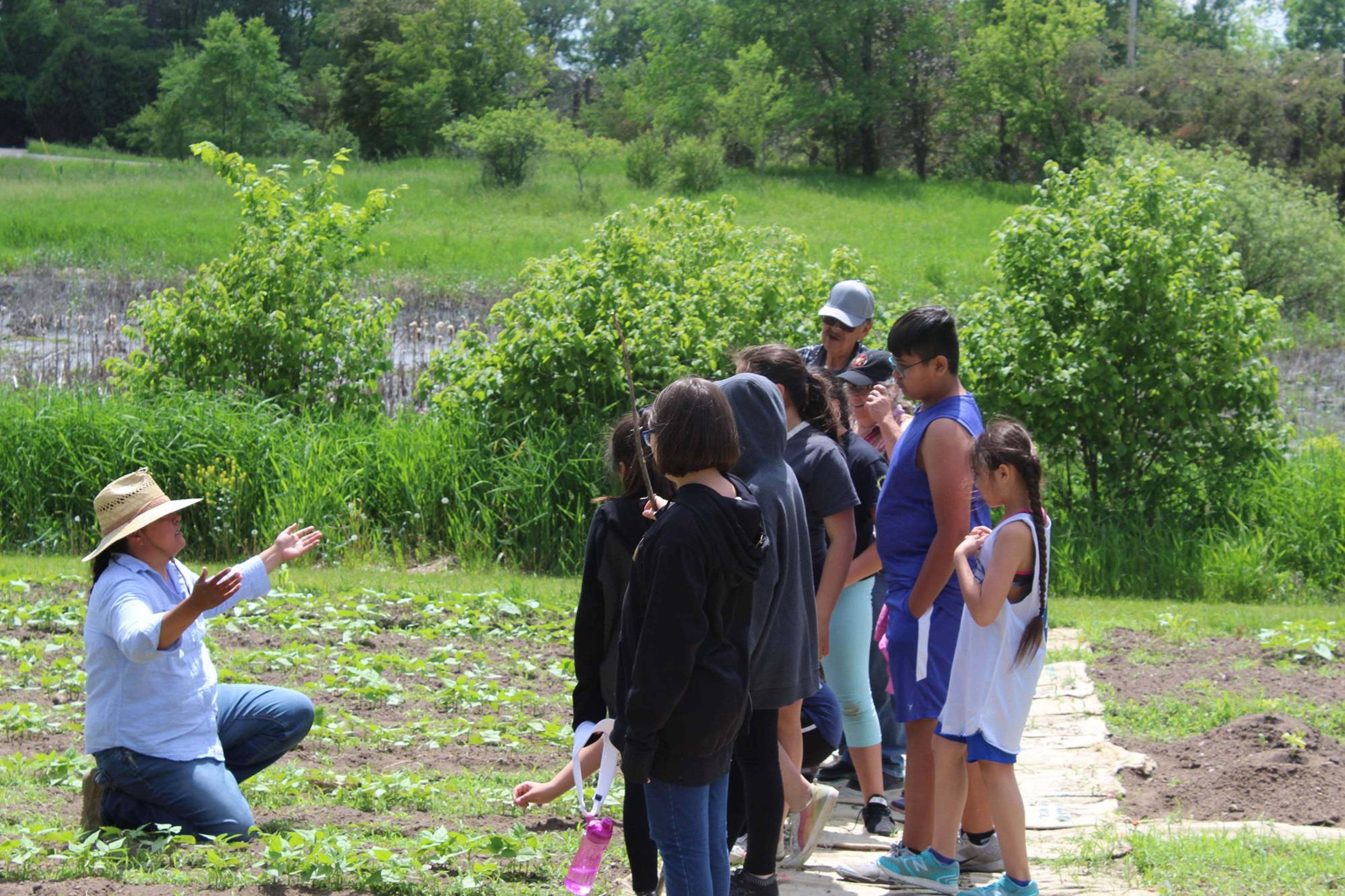 Jessika Greendeer of Dream of Wild Health Farm provides a lesson to the youth in the seed garden.