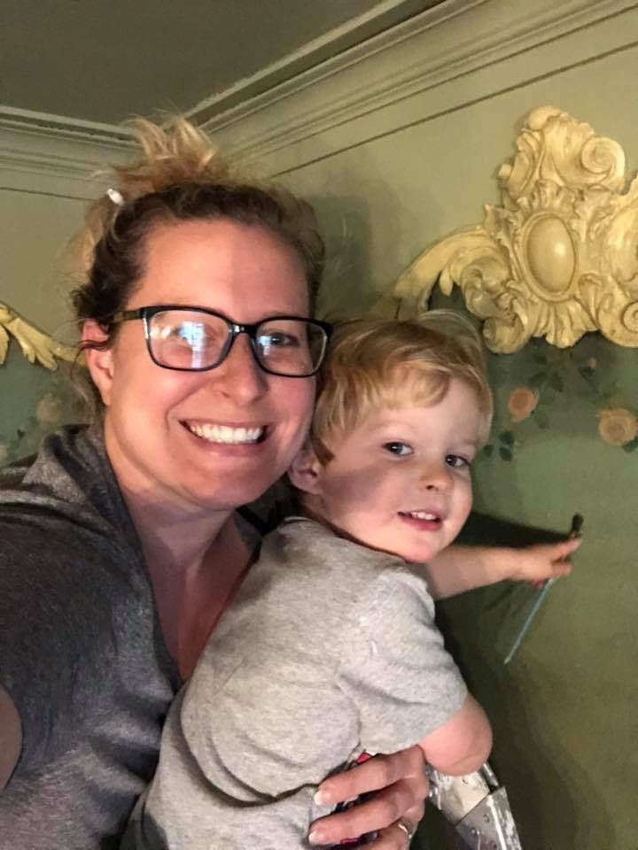 Elyse Jensen restoring the wall with her son.