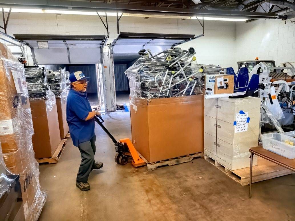 Mano a Mano co-founder Segundo Velasquez gets ready to load a collection of walkers bound for Bolivia.