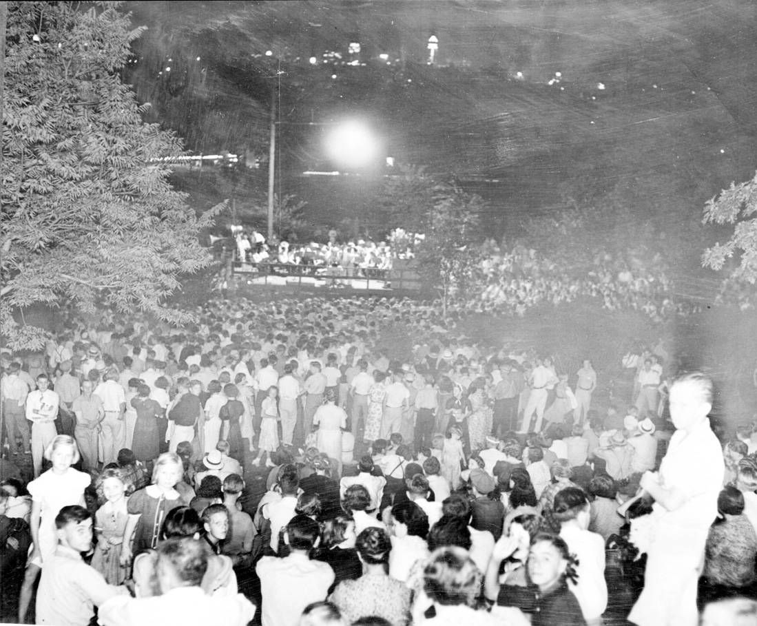 A community sings gathering on the North Side in Farview Park. Notice the lit-up Foshay in the skyline in the upper-middle part of the photo.