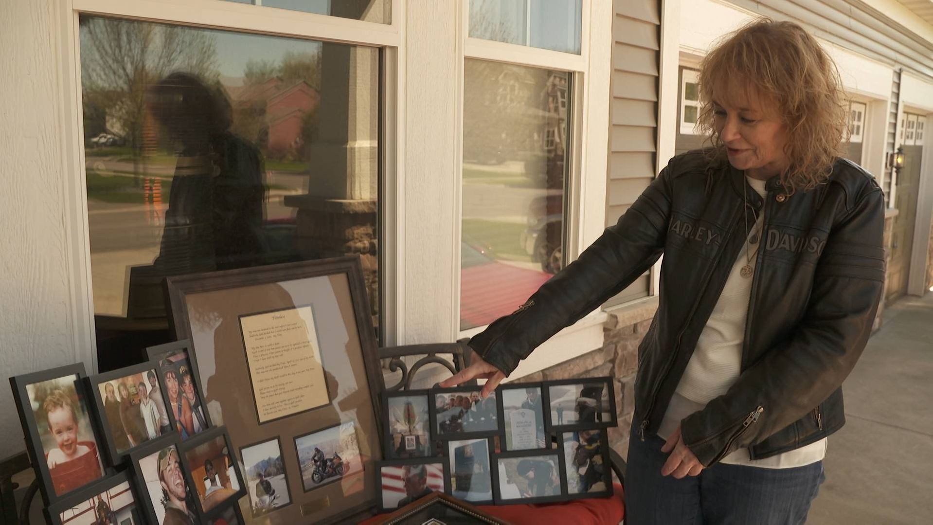 Valerie Kennedy points out photos of her son Army Specialist Joseph Alan Kennedy.