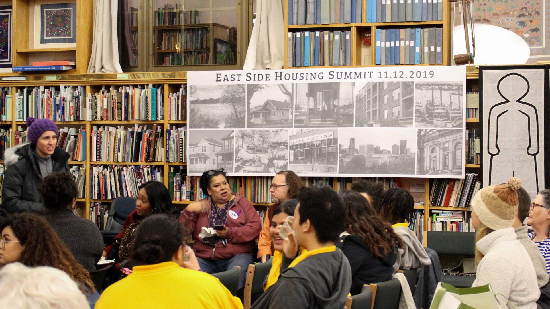 People gather at a library for an event