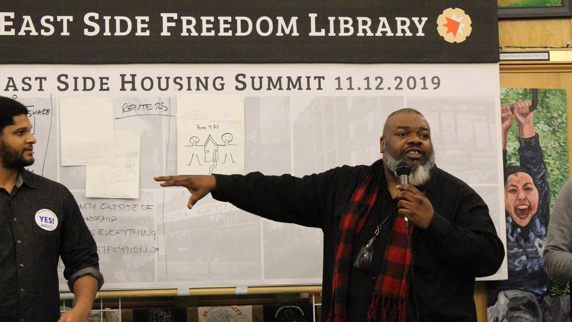 African American man talking at a library event