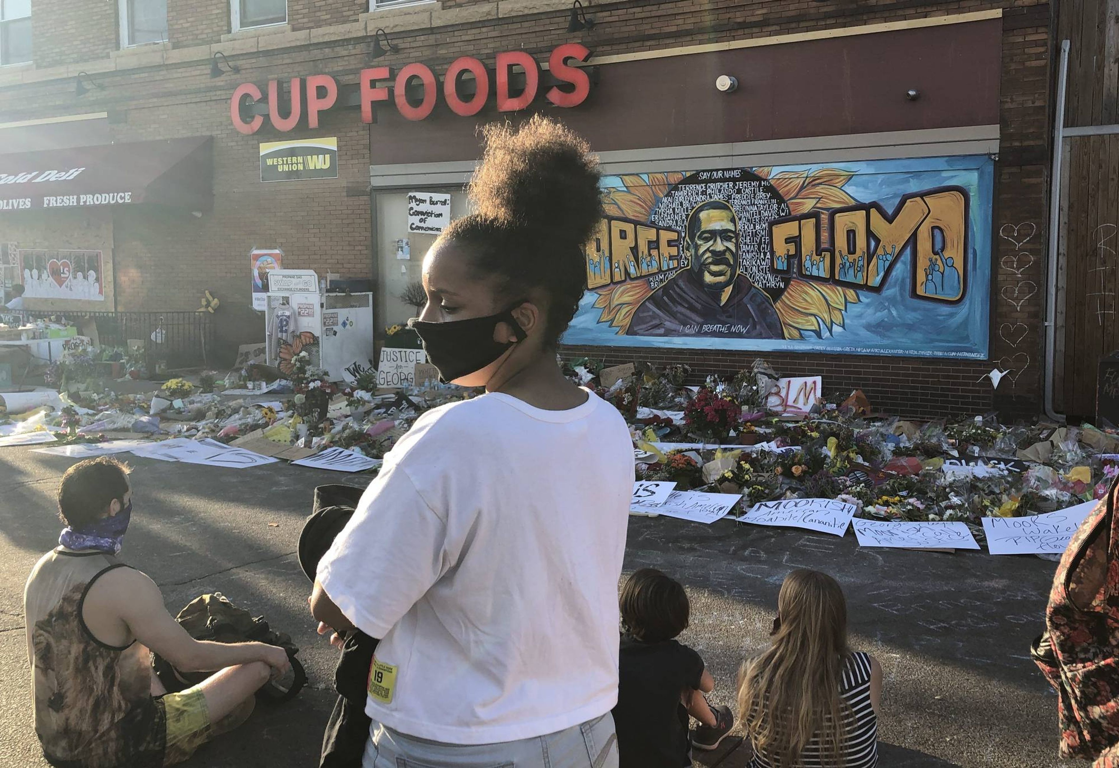 The authors' daughter at the George Floyd memorial.