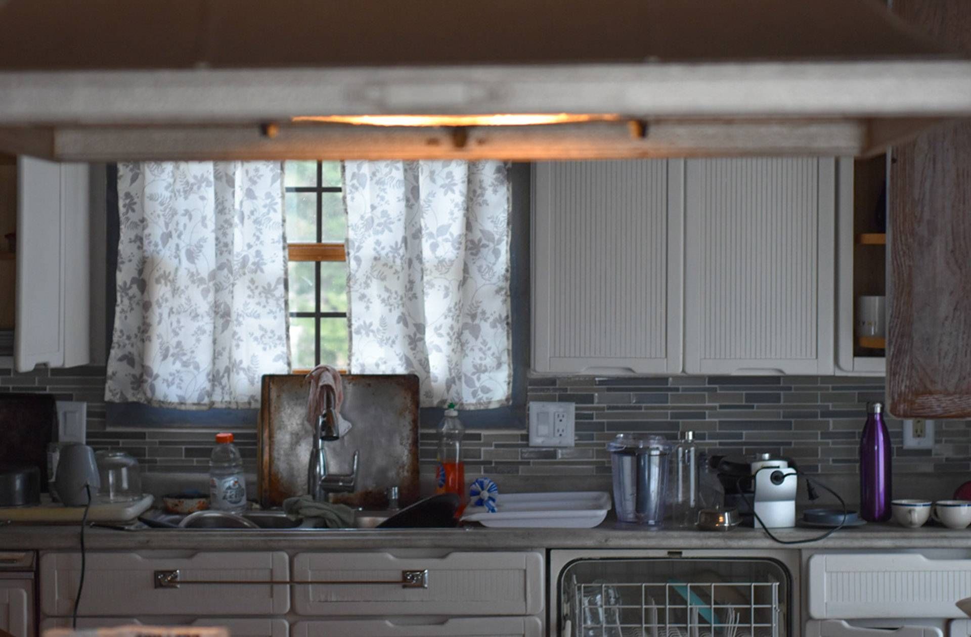 Photograph of a messy kitchen sink