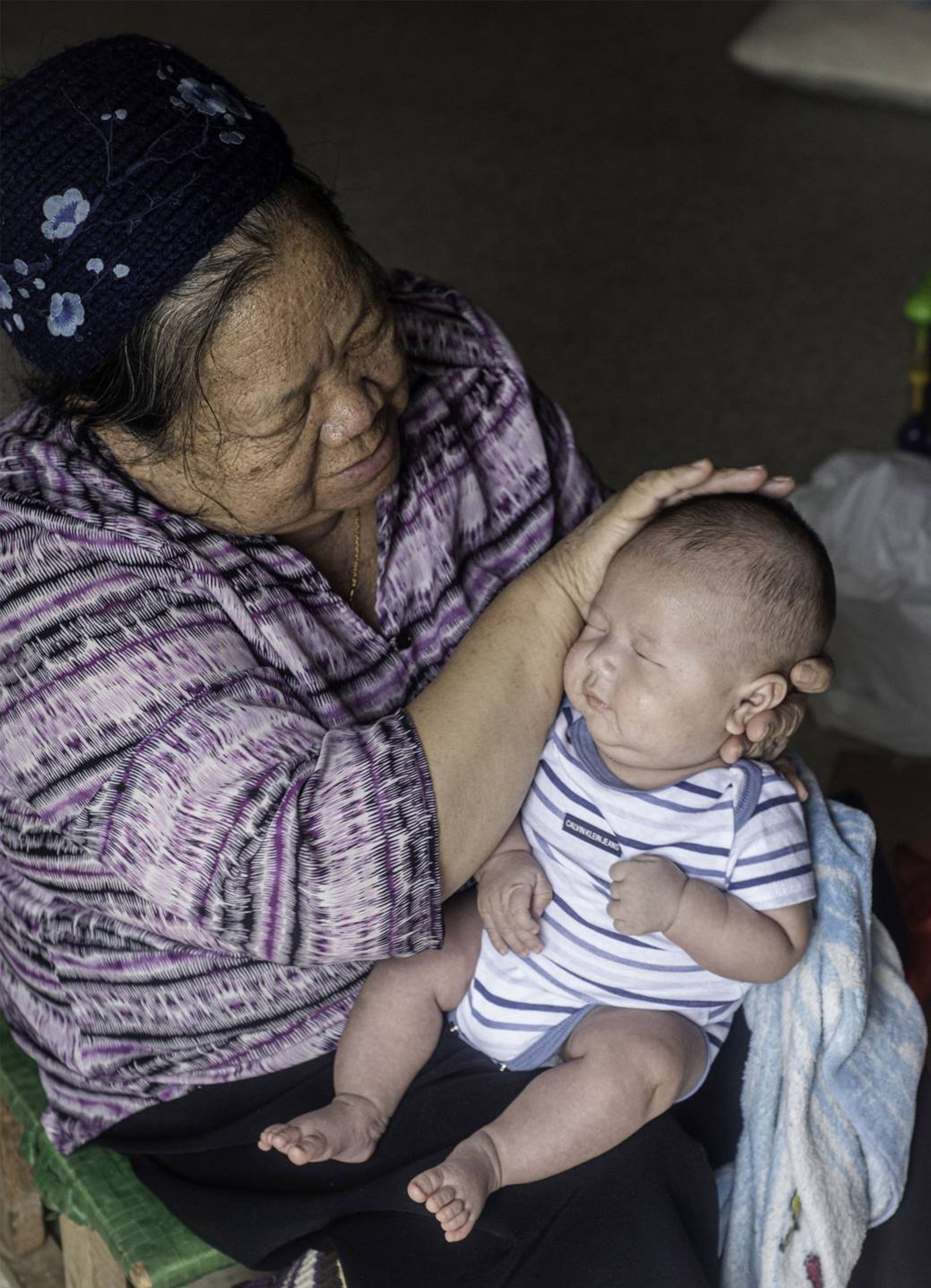 Grandmother touching baby head