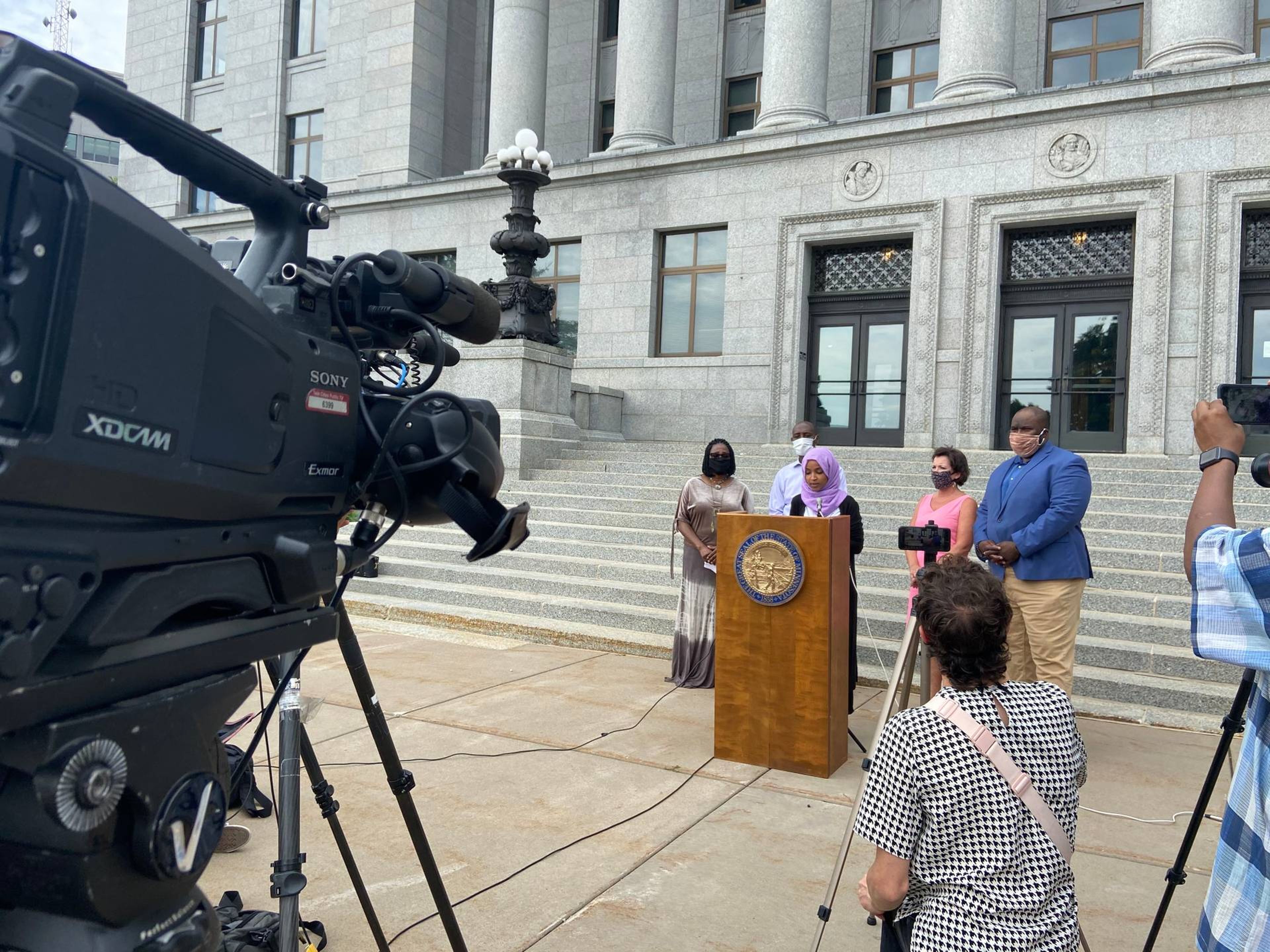 Rep. Ilhan Omar calls for action on police reform at the State Capitol.