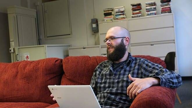 a person sitting on a couch with a laptop