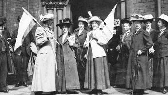Suffragists demonstrate outside of a police court.