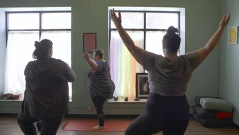 a group of people exercising in a room