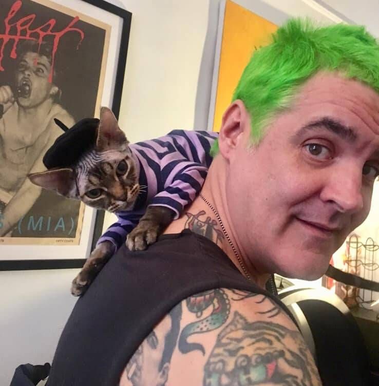 a person with a cat on his shoulder