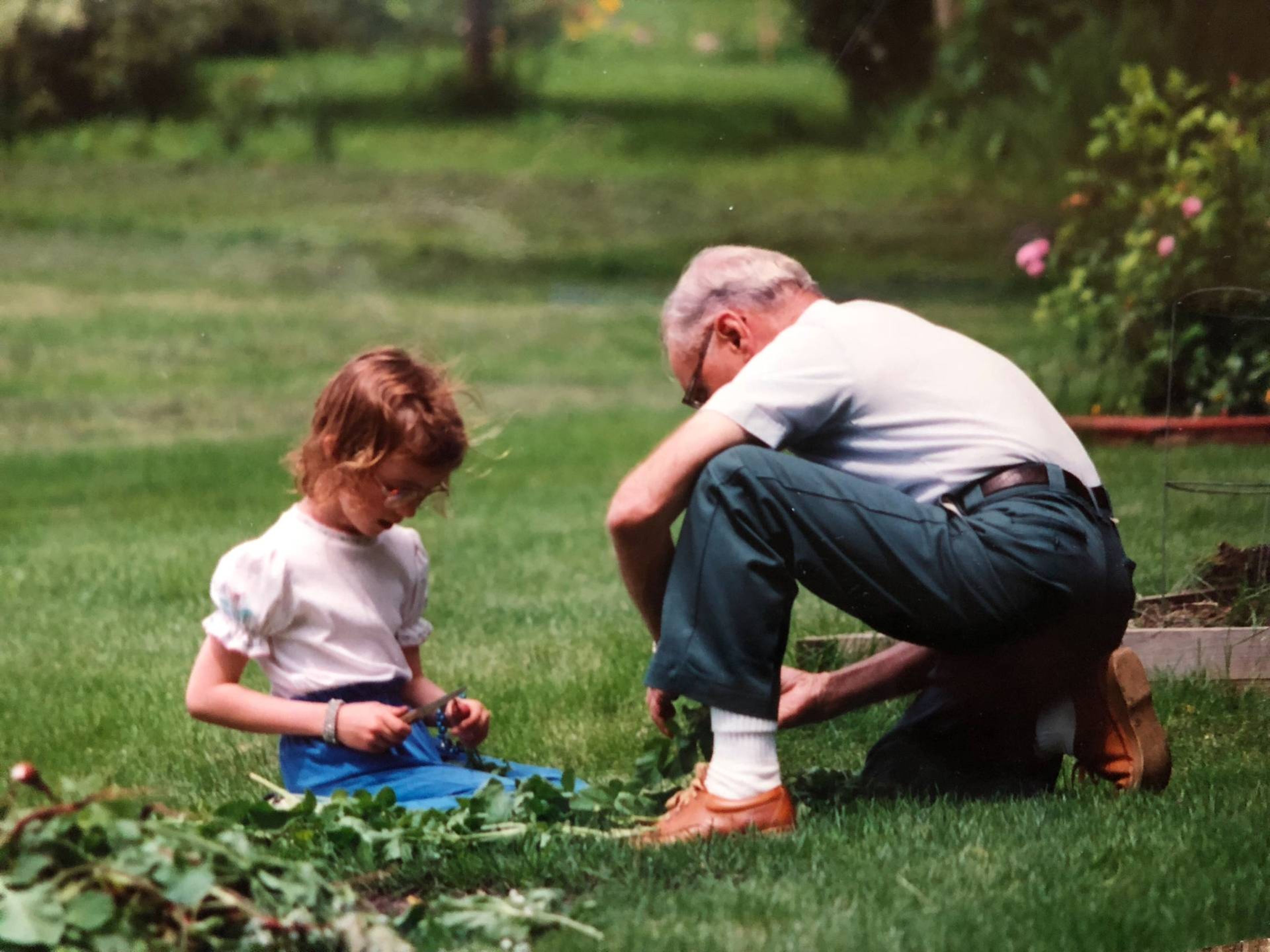 Young Karyn with her grandpa Clyde Tomlinson in the garden in Dassel, MN