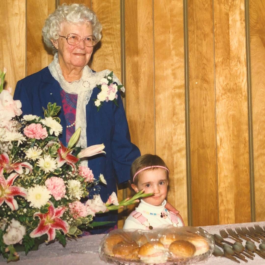 Grandma Jeanette and young Karyn Tomlinson in the church basement with what appears to be ham salad buns