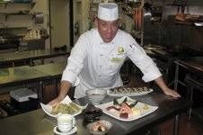 a chef preparing food in a kitchen