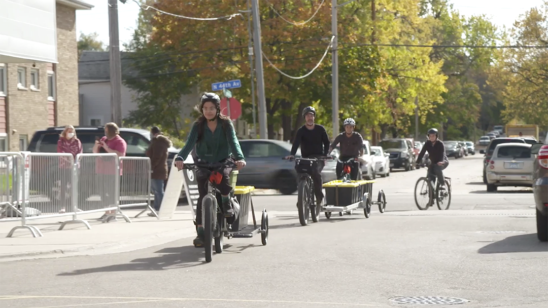 Pillsbury United Farms pays youth experiencing homelessness to transport their freshly picked produce by bicycle to local retailers.