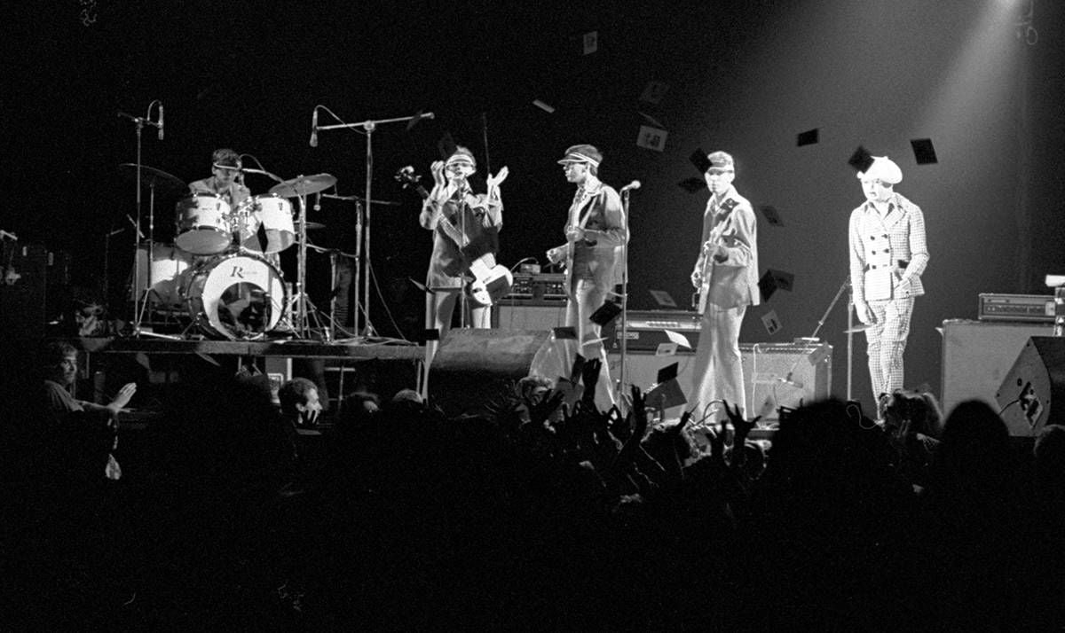 Devo performing in green leisure suits as Dove: The Band of Love, at M-80. Photo by Mike Barich.