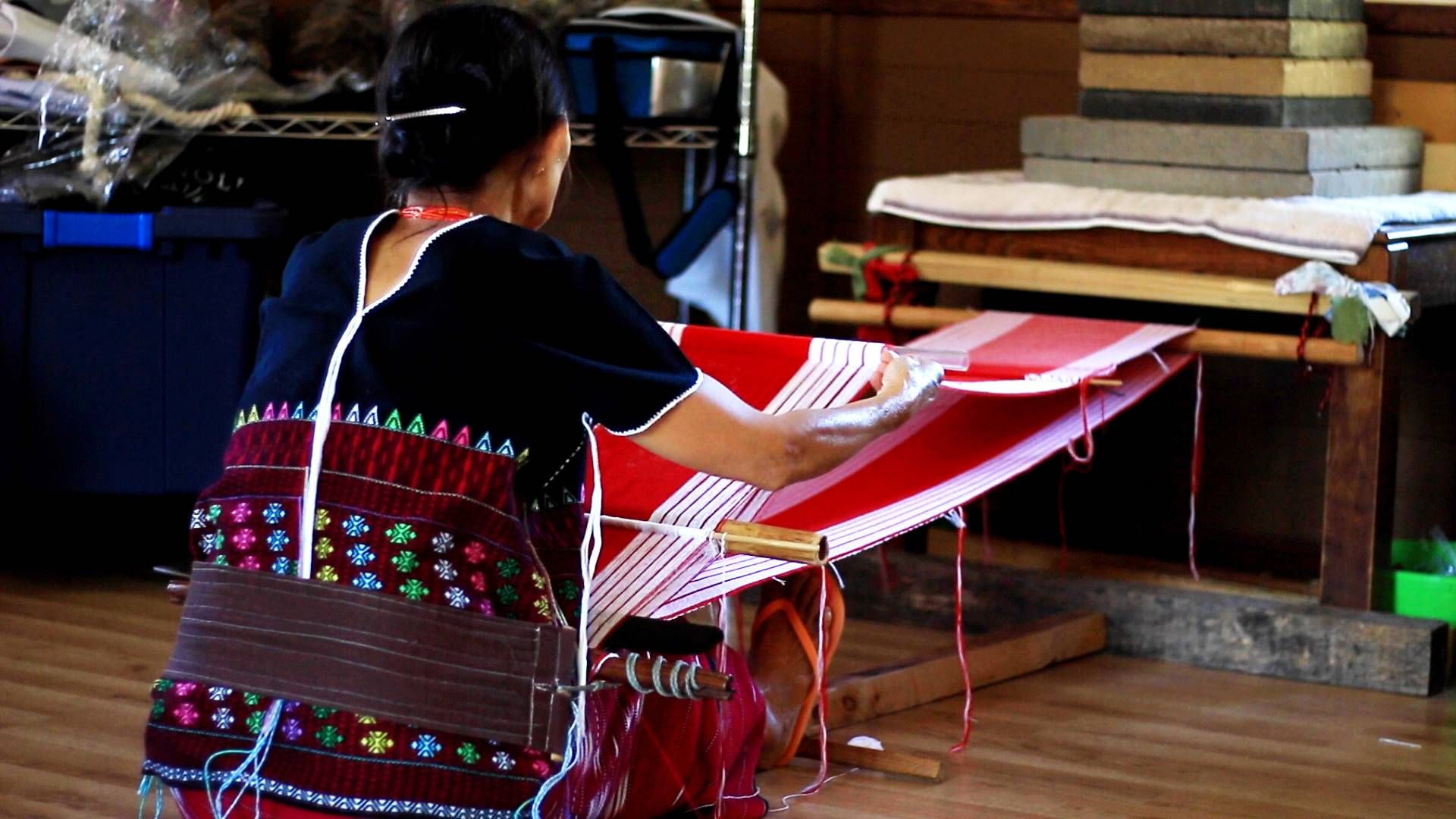 Paw weaving on her backstrap loom.