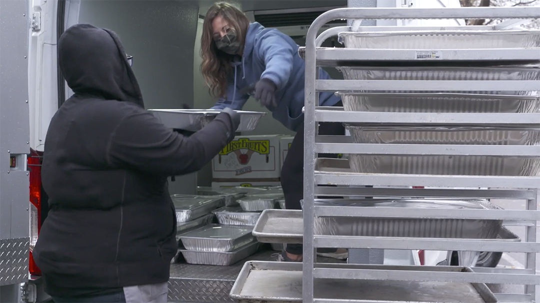 Loaves and Fishes staff load their van with freshly prepared Minnesota Central Kitchen meals that they will distribute throughout the Twin Cities.   