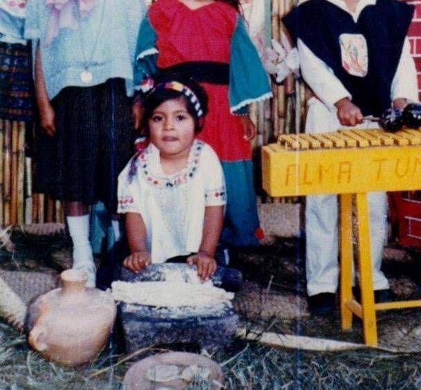 Carmen as a child in Guatemala making tortillas.
