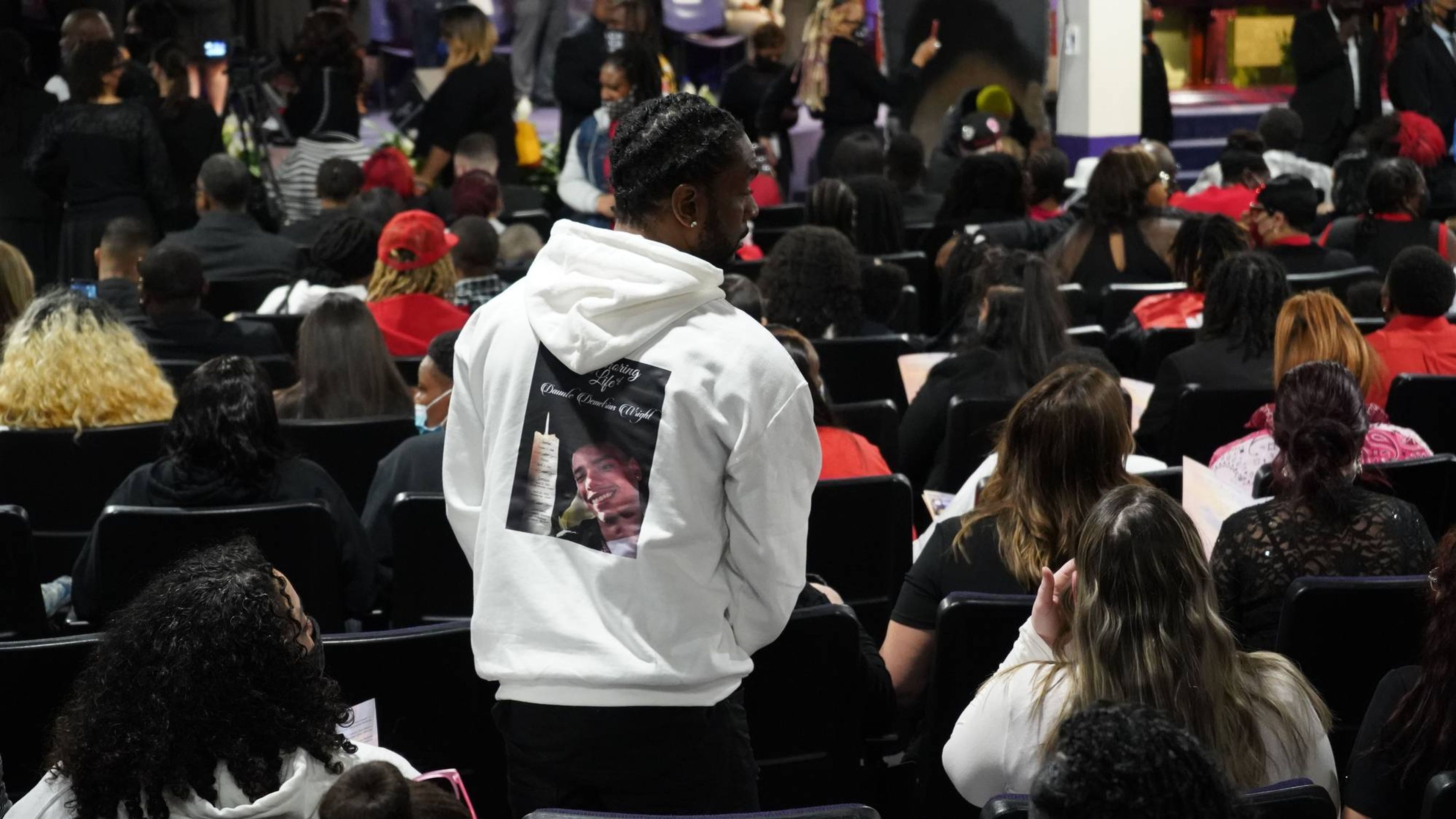 Family and friends wear pictures of Wright and "RIP Daunte Wright."