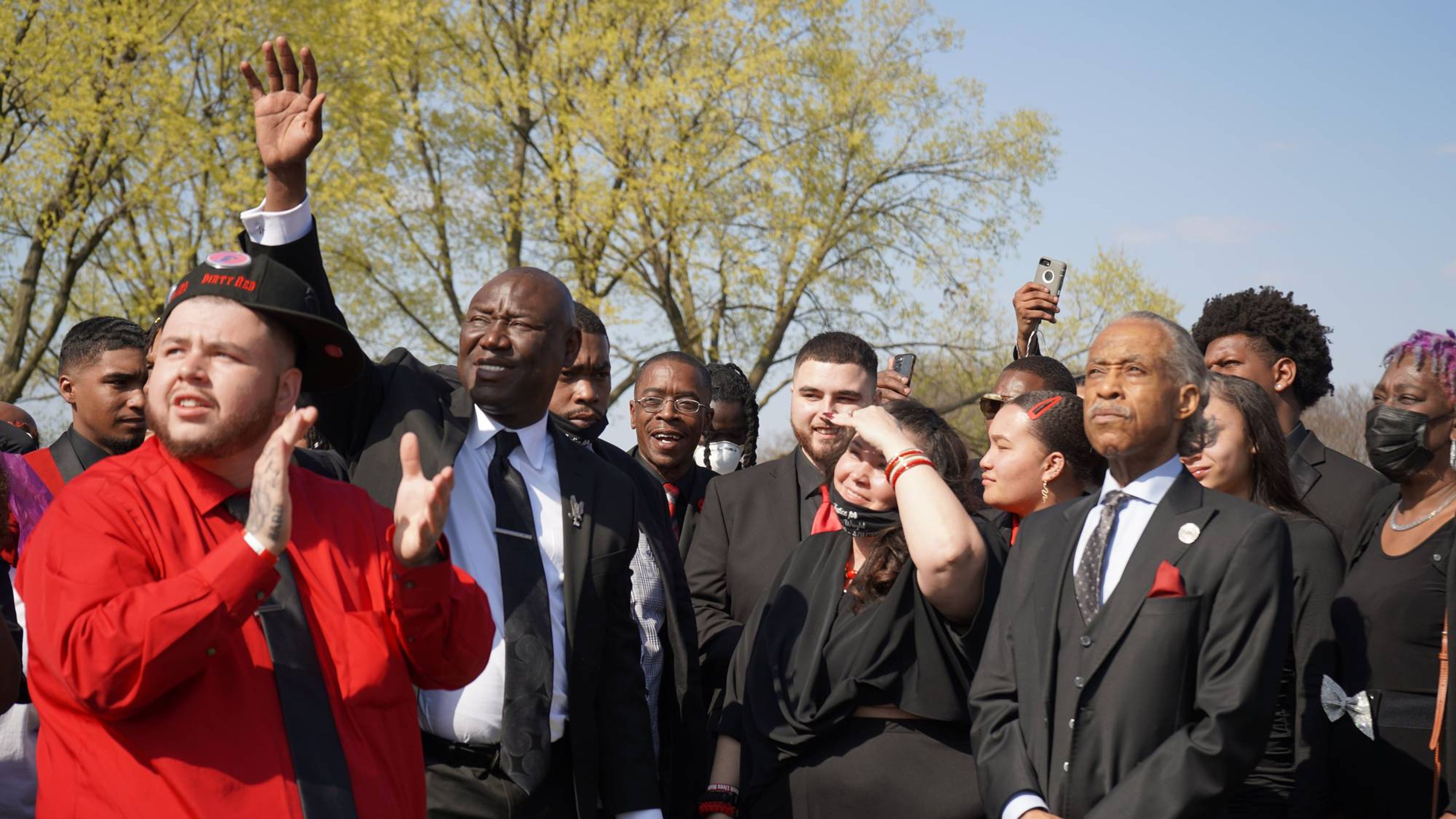 Wright, Crump, Sharpton and other mourners watch as the doves disappear, saying their final goodbyes to Daunte Wright.