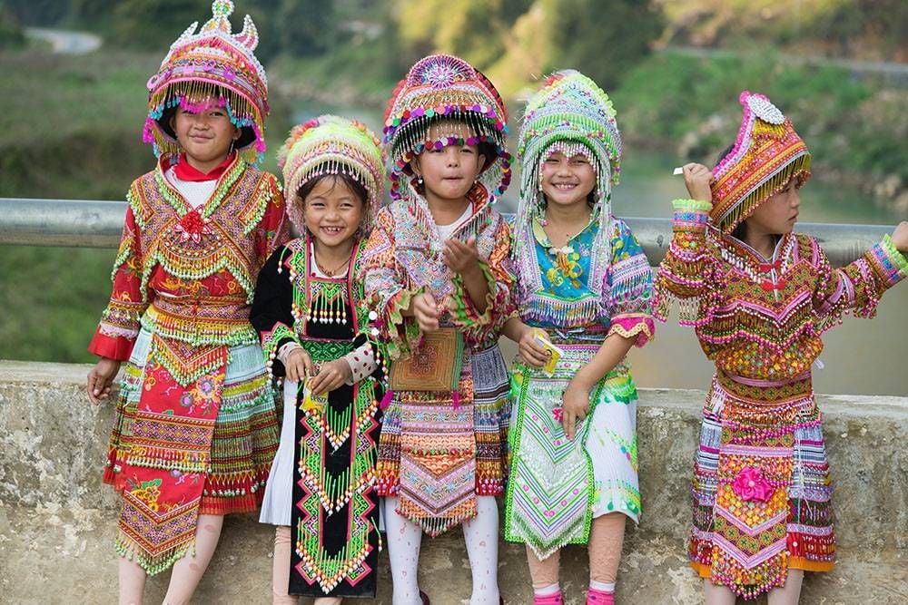 The Hmong traditional dress is very similar to the Miao dress. Both their outfits include layering fabrics, pleated skirts, similar headwear, silver jewelry and dangling adornments, as well as embroidery work. Note: These Hmong outfits are more contemporary in style.