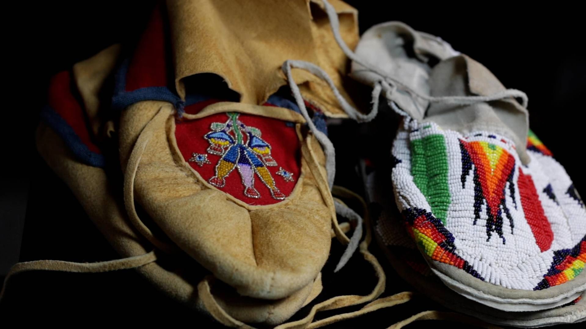 Here are two different styles of Dakota moccasins -- A traditional Woodland style (left), characterized by its puckers and curvy, linear floral beadwork designs, and a Great Plains style (right), which is usually fully beaded with more geometric designs.