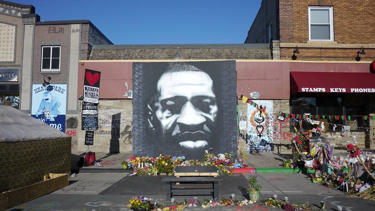 A striking black and white mural of George Floyd in George Floyd square.