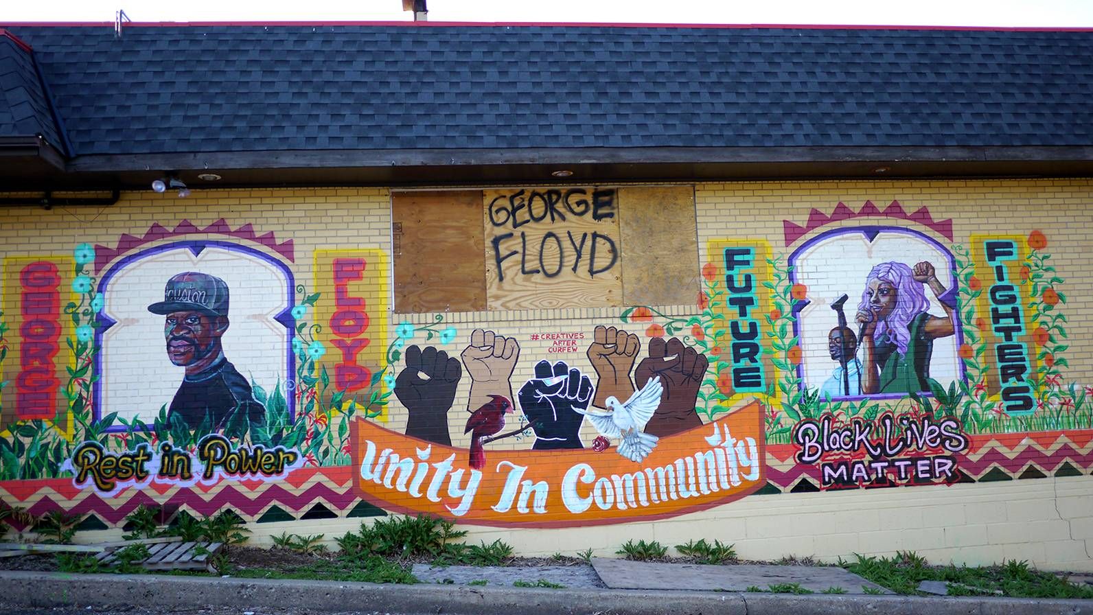 A colorful mural with the words "Unity in the Community" at the center.