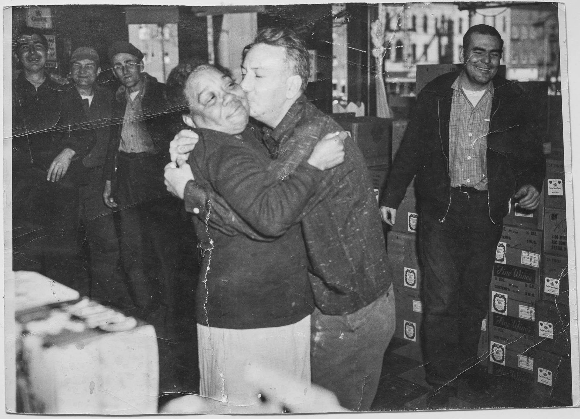 George Johnson planted a kiss on an unknown woman at Rex Liquors. Photo courtesy of John and Barbara Bacich.