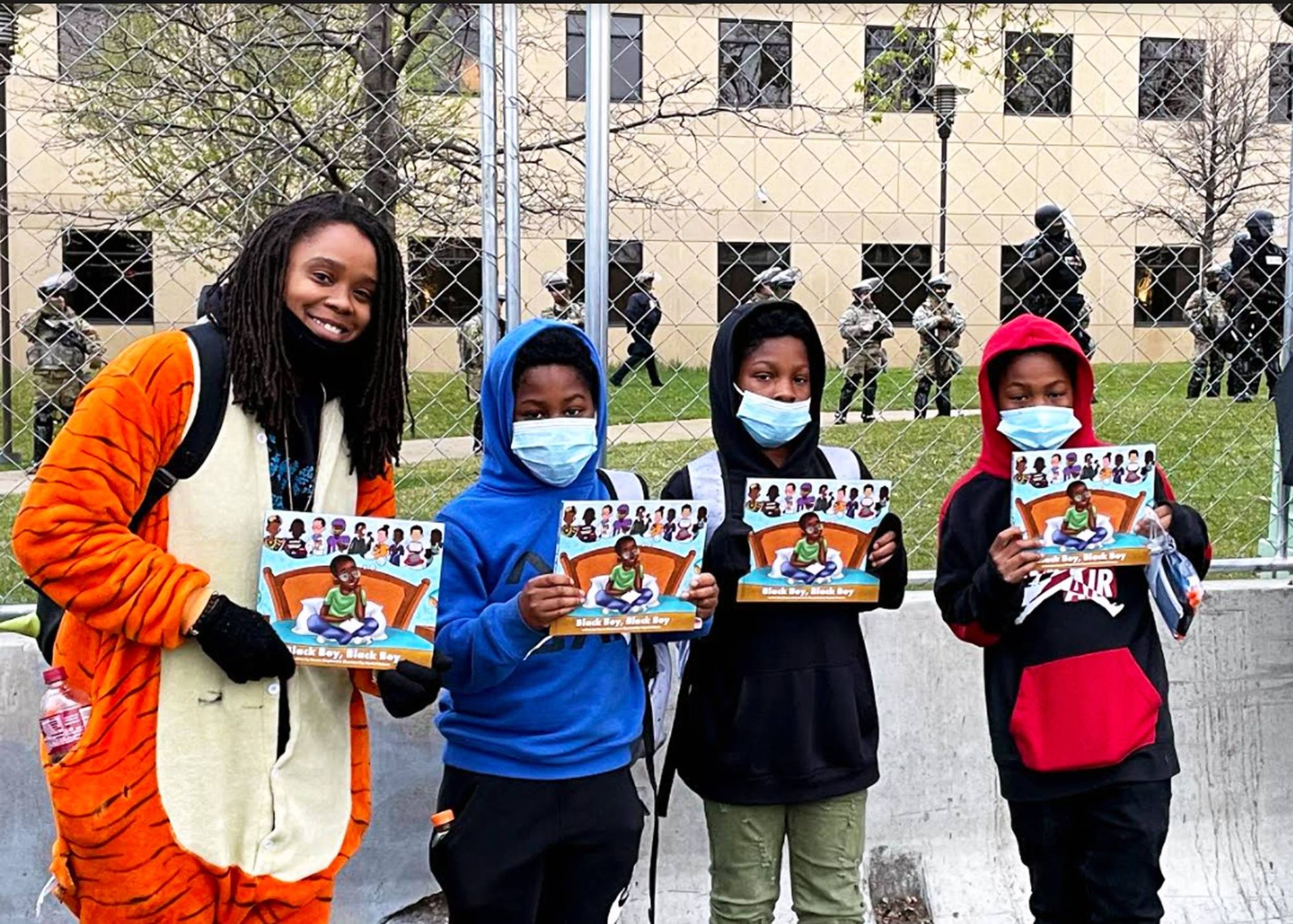 Author Crown Shepherd, a.k.a. Crown the Writer, shared her book Black Boy, Black Boy with three boys attending a protest. | Photo courtesy of Crown Shepherd.