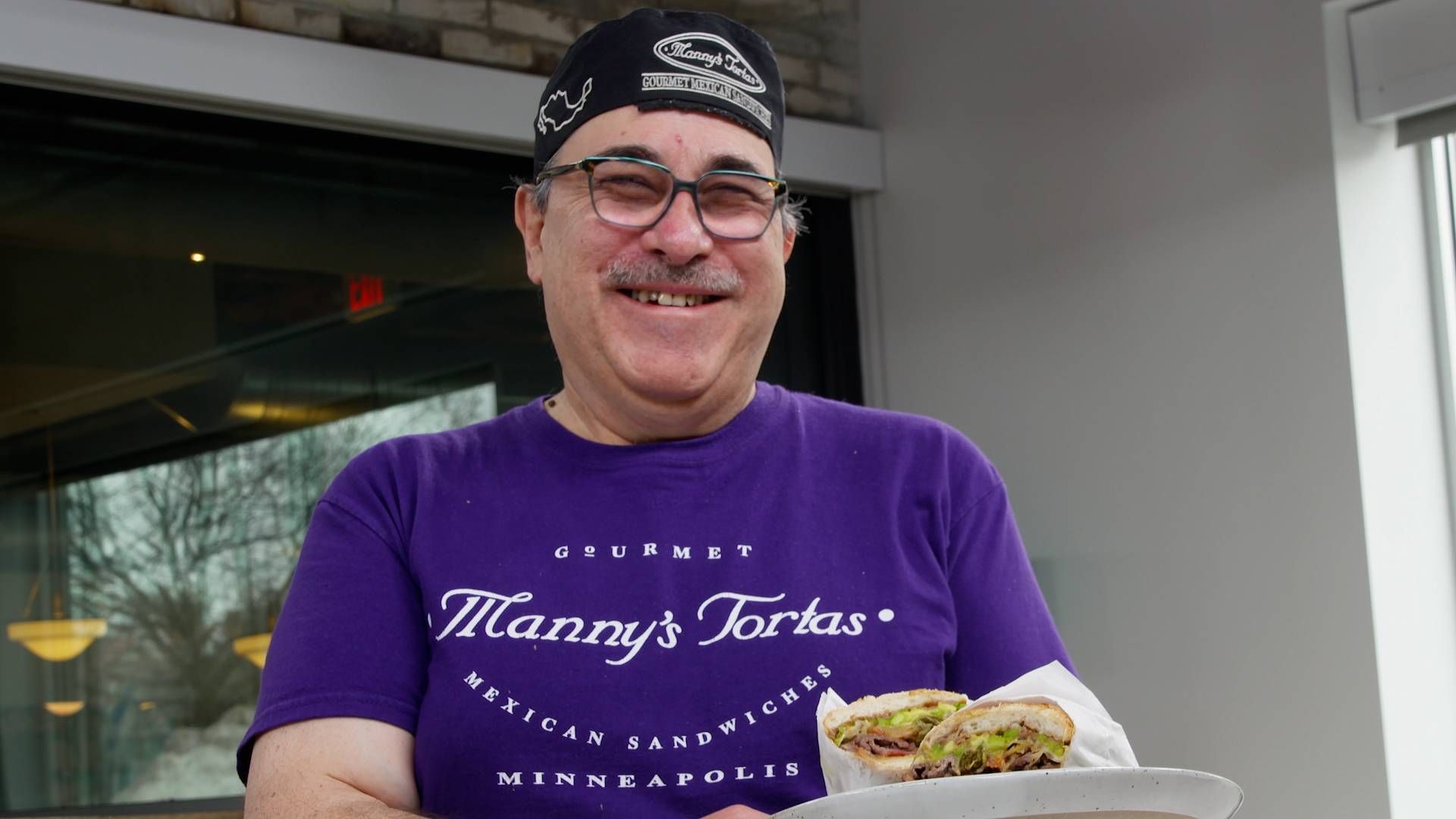 Chef Manny Gonzalez holds his signature "Manny Special" torta.