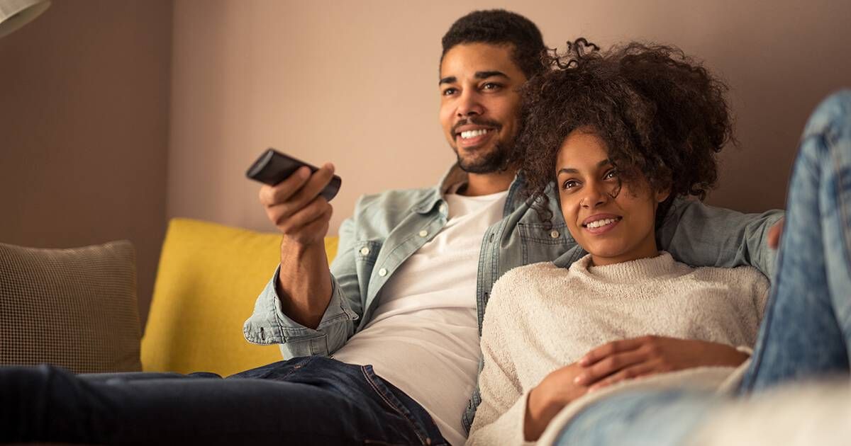 Cropped shot of a young african american couple watching television at home. Rewire PBS Love Binge-Watching