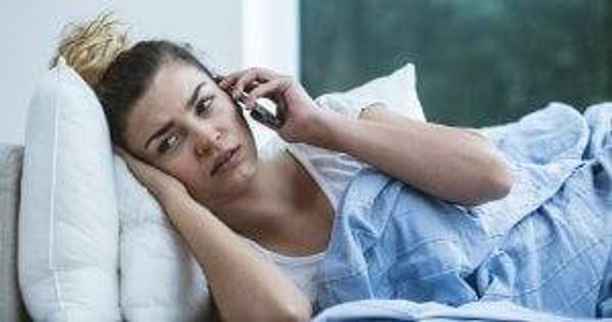 Bad feeling woman lying on the sofa with phone Emergency Room pbs rewire
