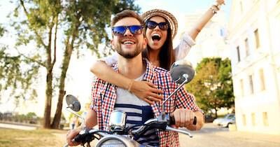 Man and woman enjoying a ride on a moped. Self-Care pbs rewire