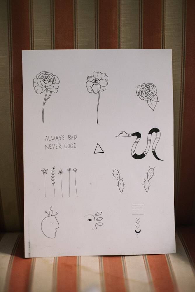 Photo of a sheet of paper with tattoo designs clients can choose from. Rewire PBS Living stick-and-poke