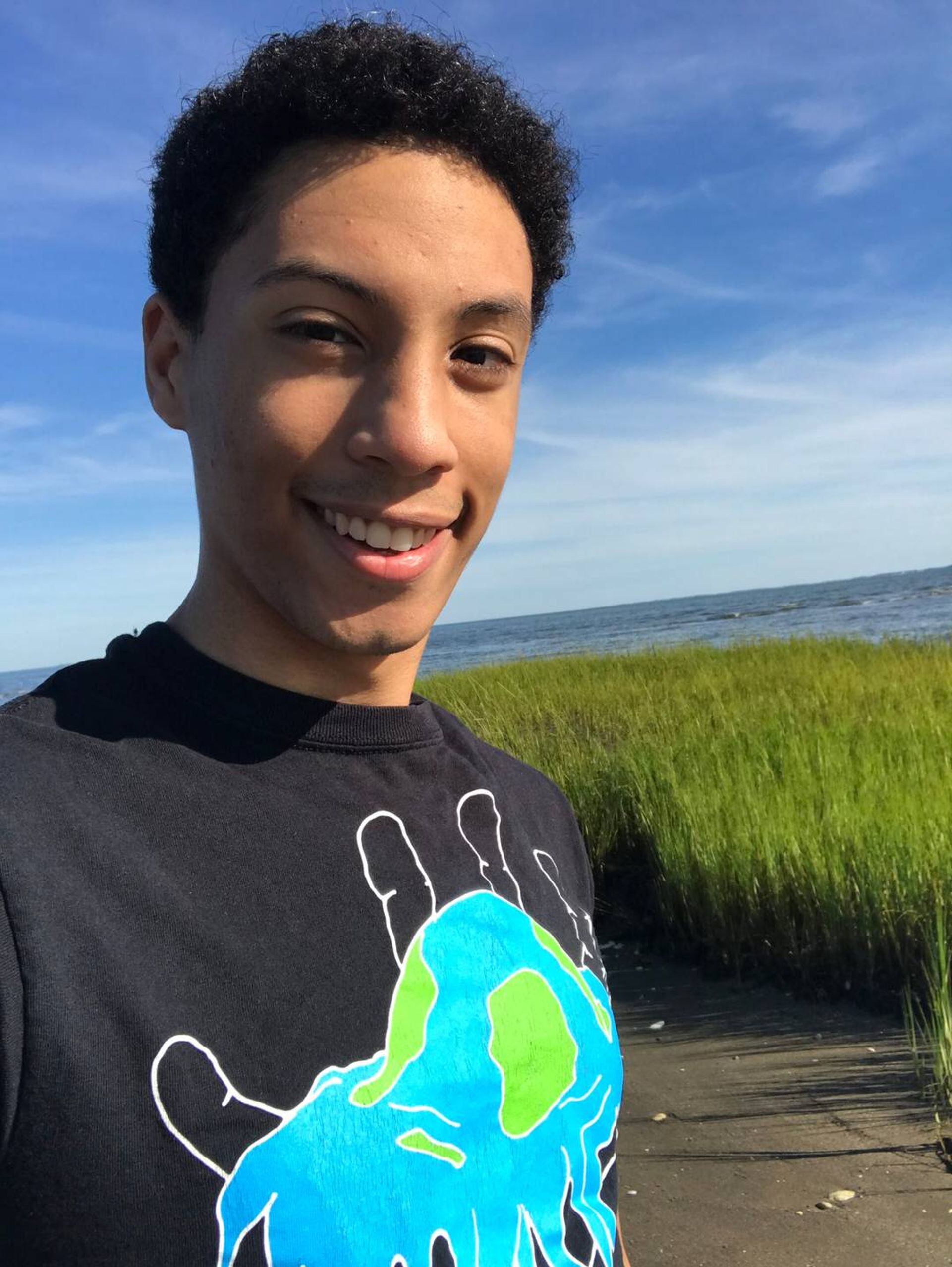 Portrait of a young man outdoors, smiling. Rewire PBS Our Future Climate Change