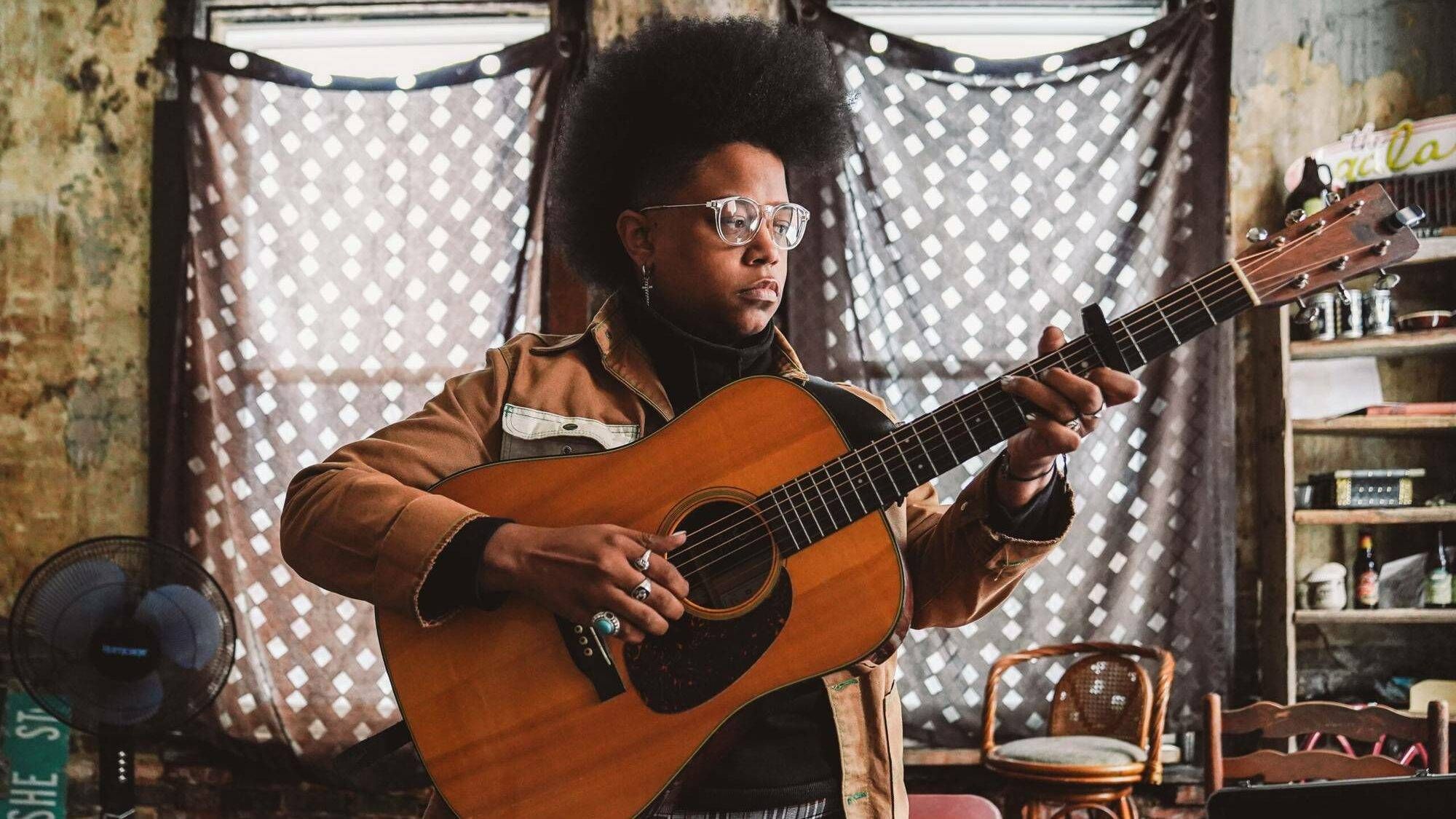 A woman plays guitar in an old apartment building, music as therapy, Rewire