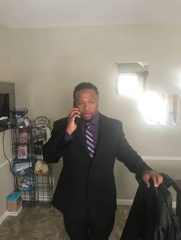 Photo of a Black man in a suit, talking on the phone. Rewire PBS Our Future Can't Vote.
